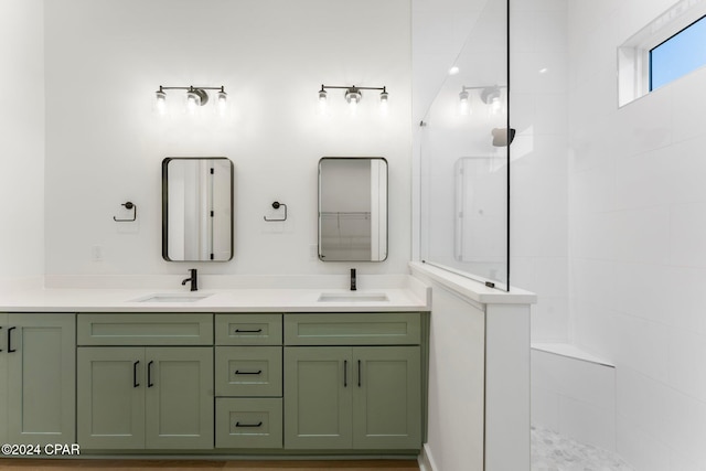 bathroom with vanity and a tile shower