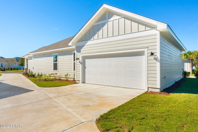 view of front of home with a garage and a front lawn