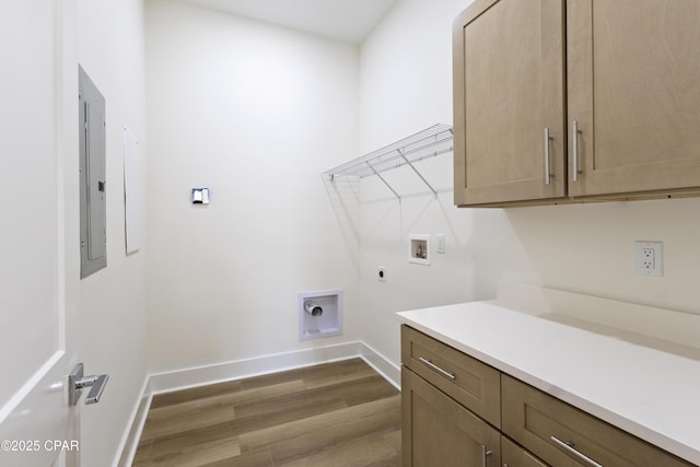 laundry room with cabinet space, baseboards, dark wood-type flooring, washer hookup, and electric dryer hookup