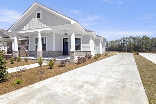 view of property exterior with a porch, board and batten siding, and brick siding