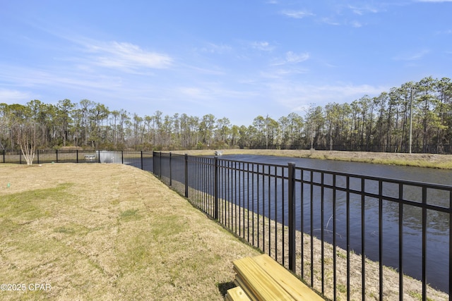 view of yard with a water view and fence