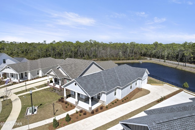 aerial view featuring a water view and a view of trees