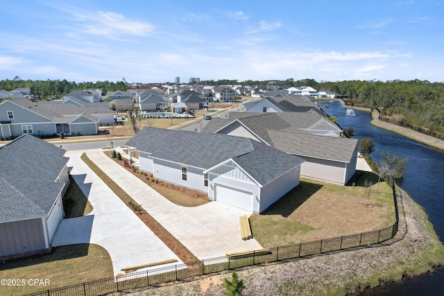 birds eye view of property featuring a water view and a residential view