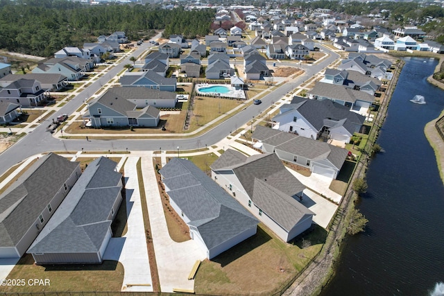 bird's eye view featuring a water view and a residential view