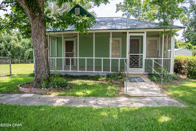 view of front of home with a front yard and covered porch