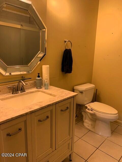 bathroom with tile patterned floors, toilet, and vanity