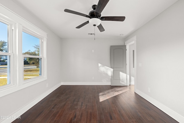 spare room featuring ceiling fan and dark hardwood / wood-style floors