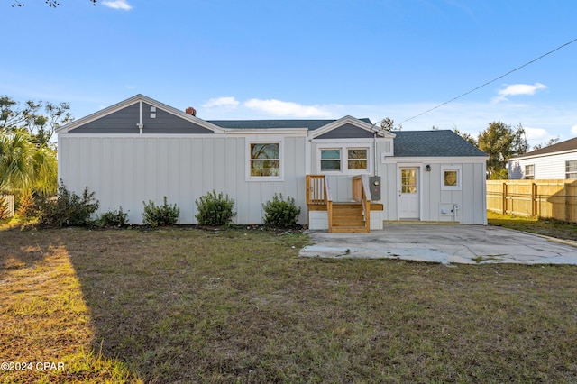 view of front of property with a patio and a front lawn