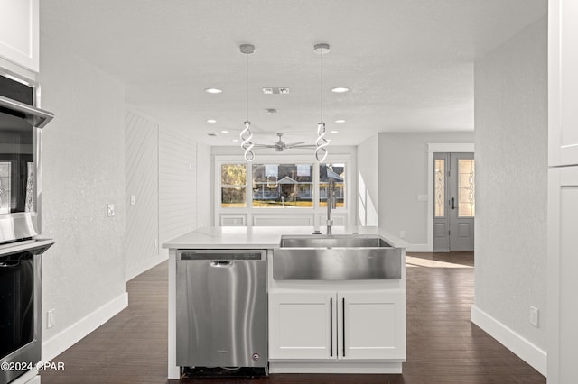 kitchen with white cabinetry, dark hardwood / wood-style flooring, hanging light fixtures, and stainless steel dishwasher