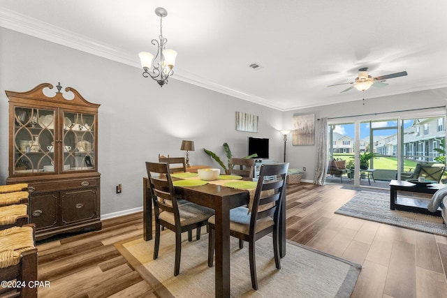 dining space featuring ceiling fan with notable chandelier, hardwood / wood-style flooring, and ornamental molding