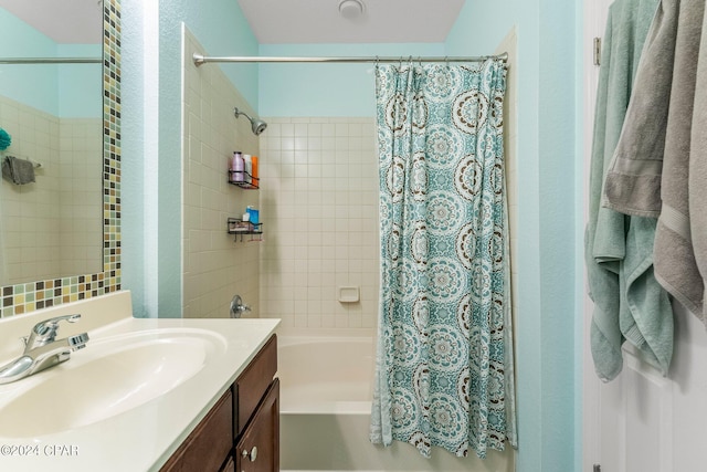 bathroom featuring vanity and shower / bathtub combination with curtain