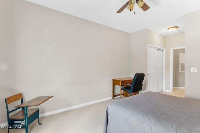 carpeted bedroom featuring ceiling fan and a closet