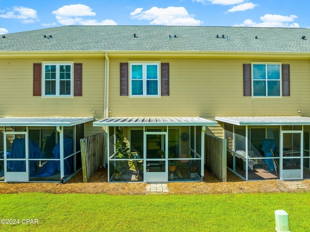 back of house featuring a sunroom and a yard