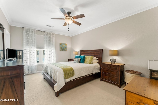 carpeted bedroom featuring ceiling fan and crown molding