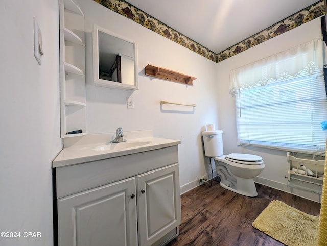 bathroom with hardwood / wood-style flooring, vanity, and toilet