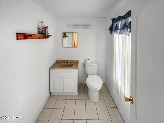 bathroom featuring tile patterned floors, vanity, and toilet