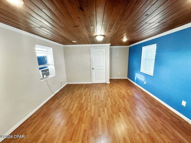 basement featuring a wealth of natural light, ornamental molding, wood ceiling, cooling unit, and light hardwood / wood-style flooring