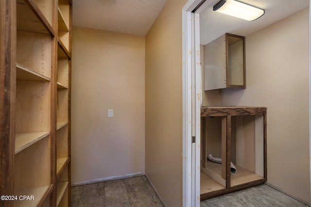 interior space with a textured ceiling and hardwood / wood-style floors