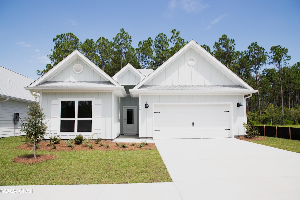 view of front of home with a garage and a front yard