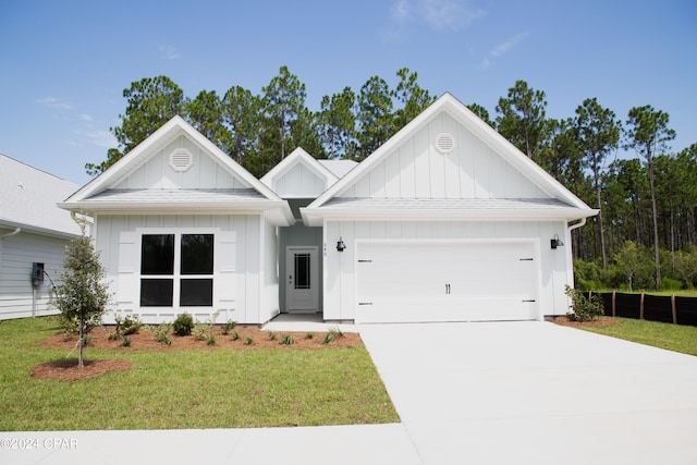 view of front of home with a garage and a front yard