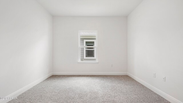 unfurnished bedroom featuring light colored carpet and a closet