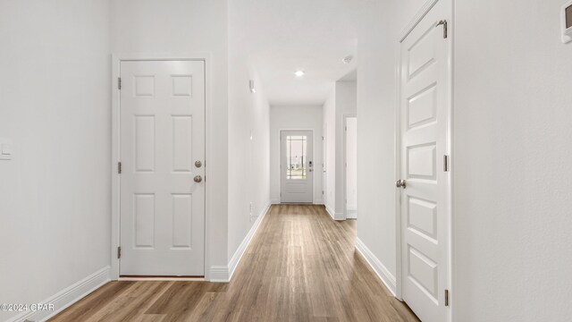 kitchen featuring appliances with stainless steel finishes, sink, a kitchen island with sink, white cabinetry, and hardwood / wood-style flooring