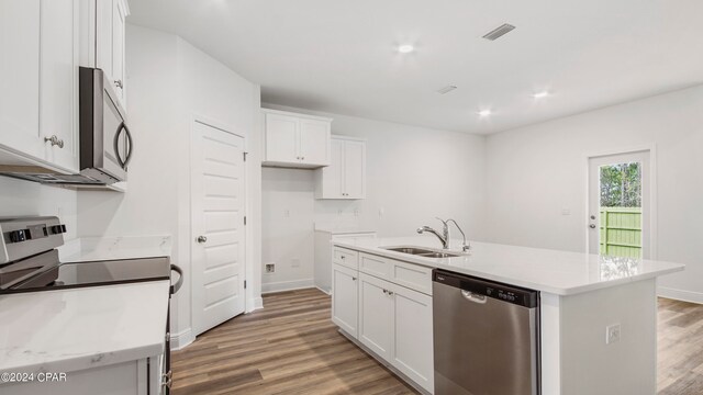 kitchen featuring hardwood / wood-style floors, a kitchen island with sink, appliances with stainless steel finishes, and sink