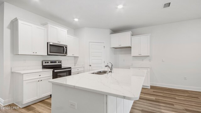 kitchen featuring sink, light hardwood / wood-style flooring, a wealth of natural light, and white cabinets