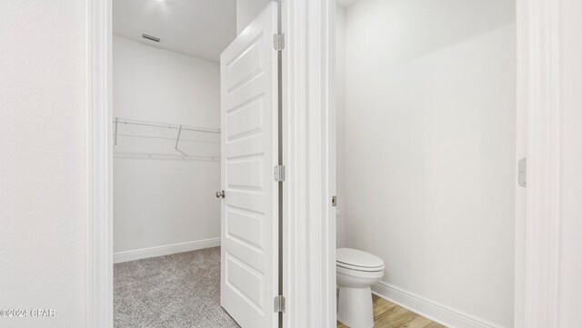 bathroom with plus walk in shower, vanity, and hardwood / wood-style flooring