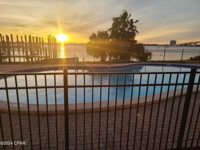 pool at dusk with a water view