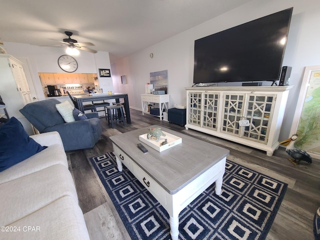 living room featuring ceiling fan and dark hardwood / wood-style floors