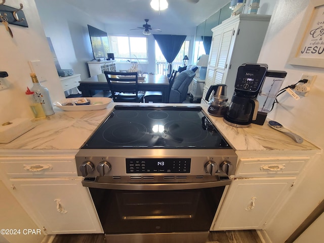 kitchen with white cabinetry, electric range, and ceiling fan