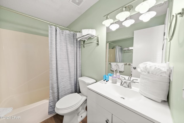 full bathroom with vanity, shower / bath combination with curtain, and toilet