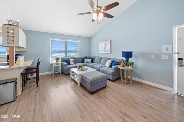 living room with ceiling fan, high vaulted ceiling, and light wood-type flooring