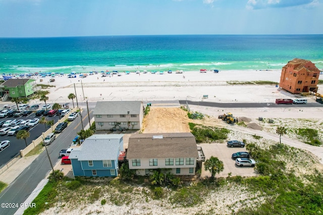 drone / aerial view with a water view and a beach view