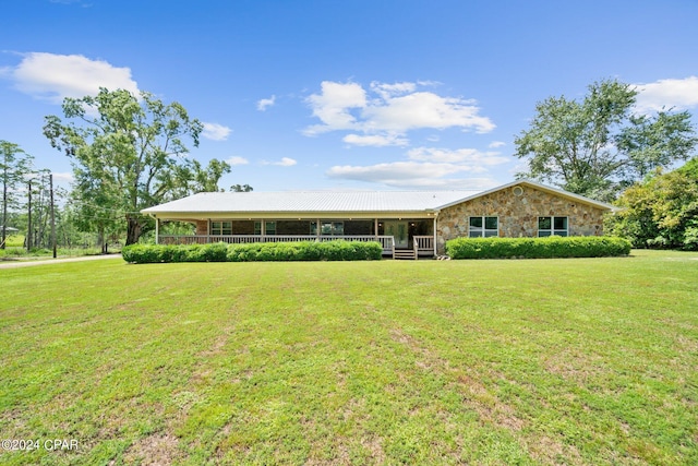 single story home featuring covered porch and a front lawn