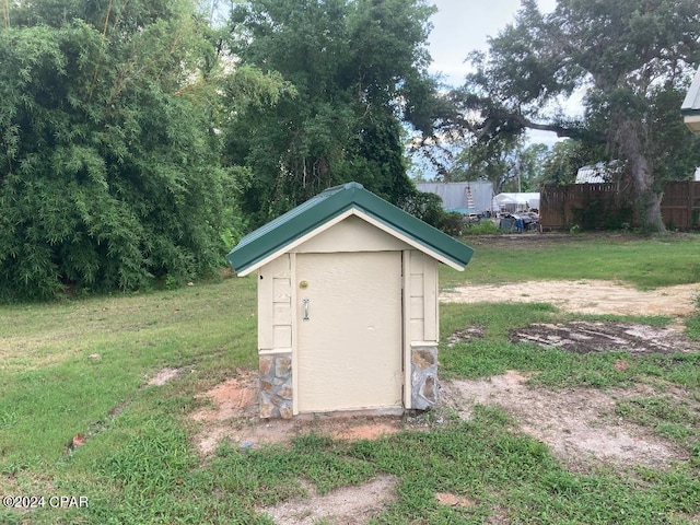 view of outbuilding featuring a lawn