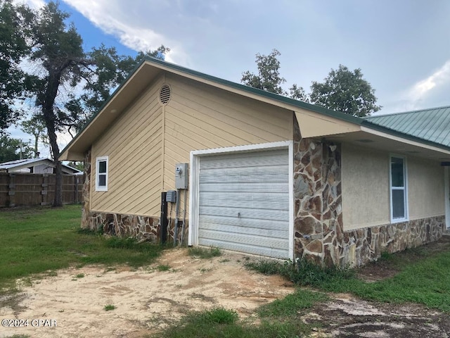 view of side of property with a garage