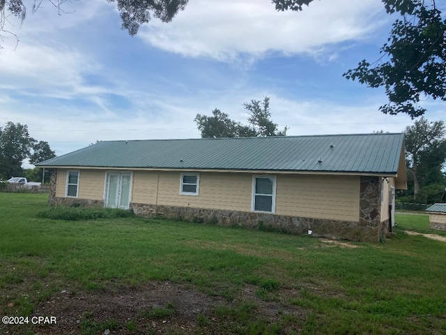 rear view of house with a yard