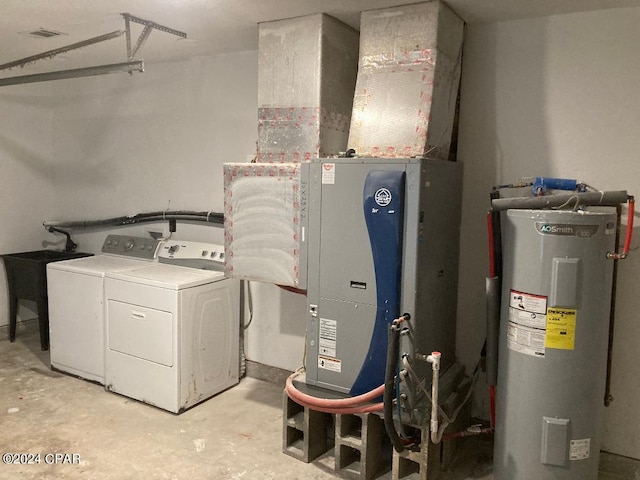 clothes washing area featuring washer and dryer and water heater