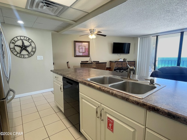 kitchen featuring stainless steel fridge, dishwasher, light tile patterned floors, ceiling fan, and sink