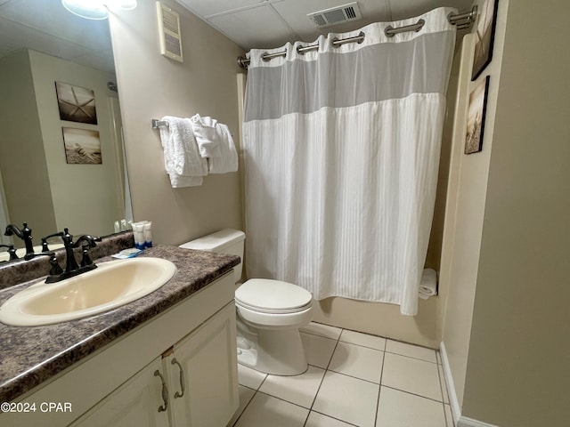 full bathroom featuring vanity, toilet, shower / bath combo with shower curtain, and tile patterned floors