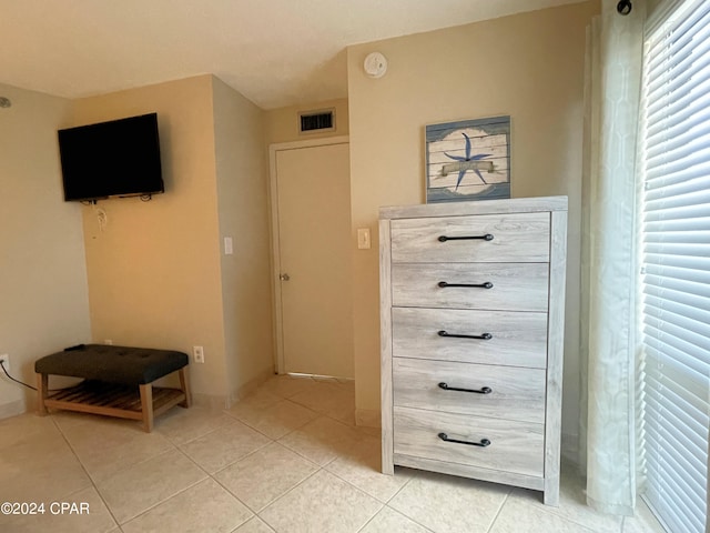 bedroom with light tile patterned floors