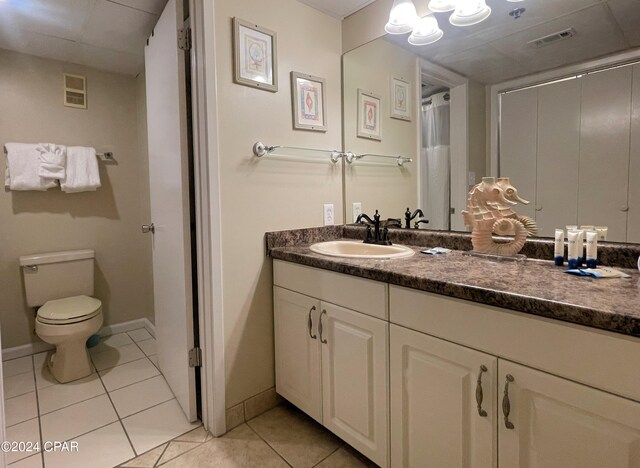 bathroom featuring tile patterned floors, vanity, and toilet