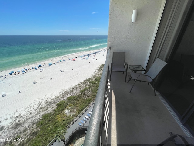 balcony featuring a water view and a view of the beach