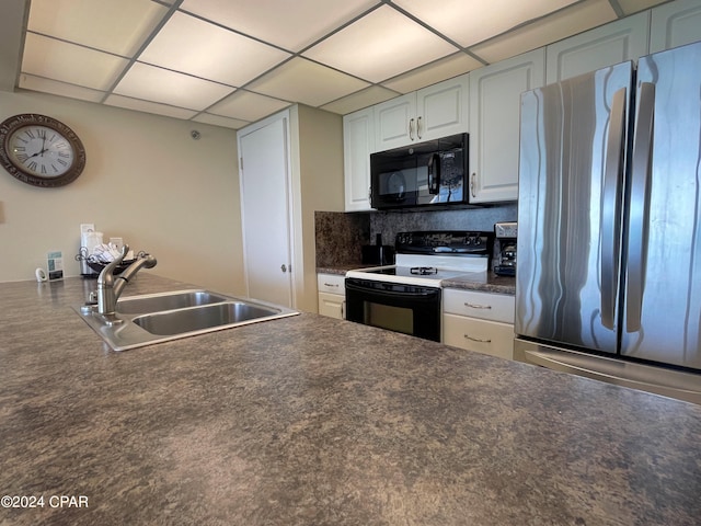 kitchen with decorative backsplash, white cabinets, stainless steel refrigerator, white electric stove, and sink