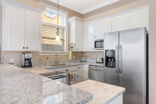 kitchen with stainless steel appliances, sink, hanging light fixtures, and white cabinets