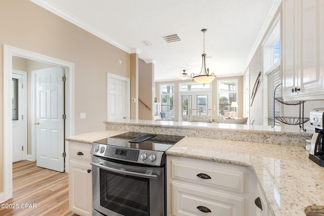 kitchen featuring white cabinetry, pendant lighting, light stone countertops, and electric range