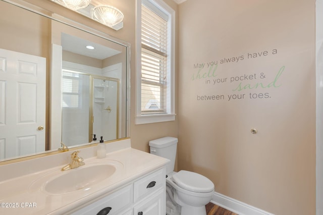 bathroom featuring vanity, toilet, and walk in shower