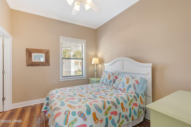 bedroom with crown molding, dark hardwood / wood-style floors, and ceiling fan